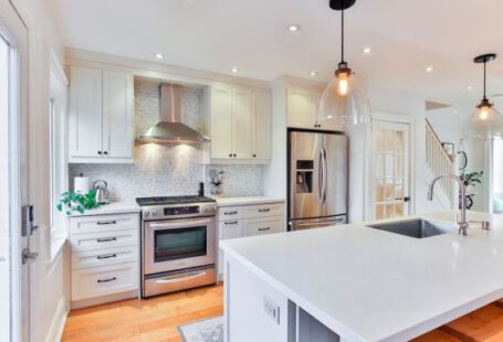 Kitchen - white wooden kitchen cabinet and white kitchen counter
