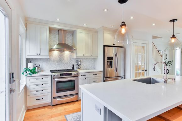 Kitchen - white wooden kitchen cabinet and white kitchen counter