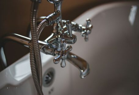 Plumbing - silver water faucet on white ceramic sink