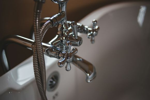 Plumbing - silver water faucet on white ceramic sink