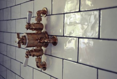 Plumbing - brass door knob on white ceramic tile