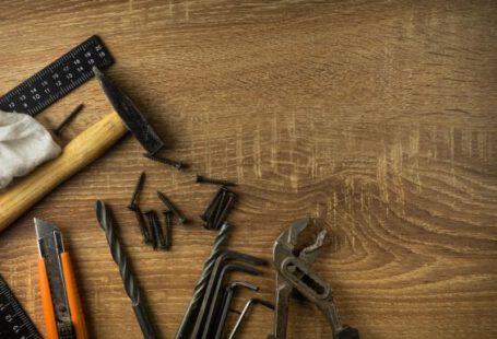 Plumbing - brown wooden handle gray metal tool