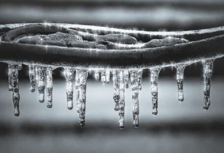 Snow Pipes - grayscale photography of water drops ice