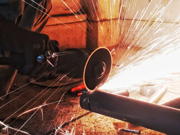 Plumber - person grinding pipe steel wool photography