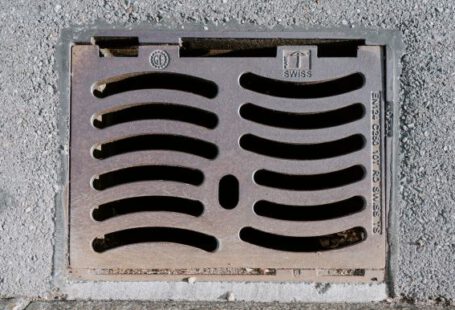 Drain - a manhole cover on the side of a building